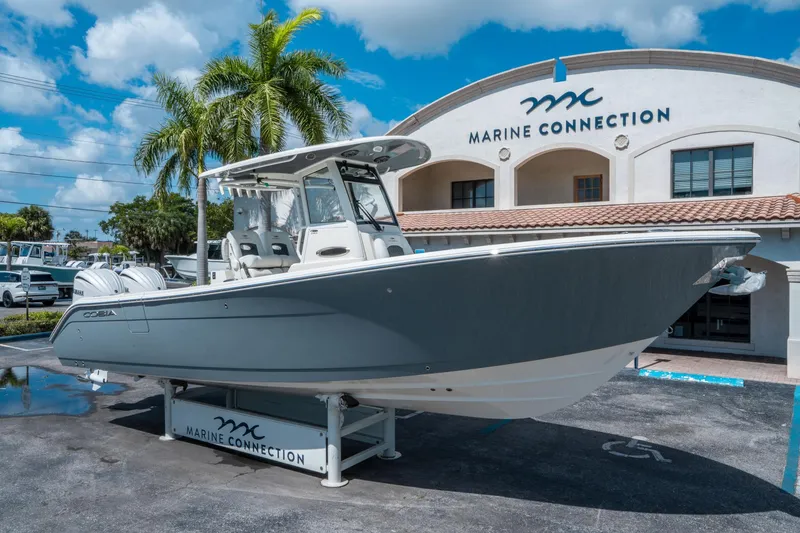 Slide: The Image of 2025 Cobia 285 CC boat displayed at Marine Connection dealership. - 8
