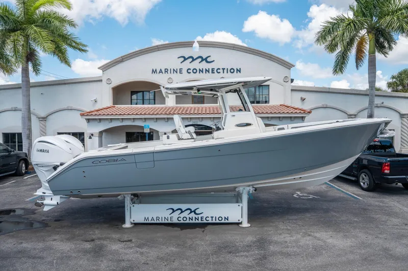 Slide: The Image of 2025 Cobia 285 CC boat displayed at Marine Connection dealership. - 1
