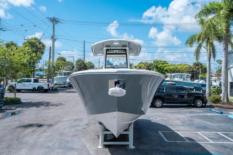 Slide: The Image of 2025 Cobia 285 CC boat displayed outdoors on a sunny day. - 7
