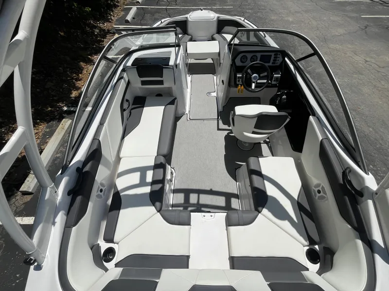 Slide: The Image of 2022 Yamaha AR210 boat interior with sleek seating and modern dashboard. - 12
