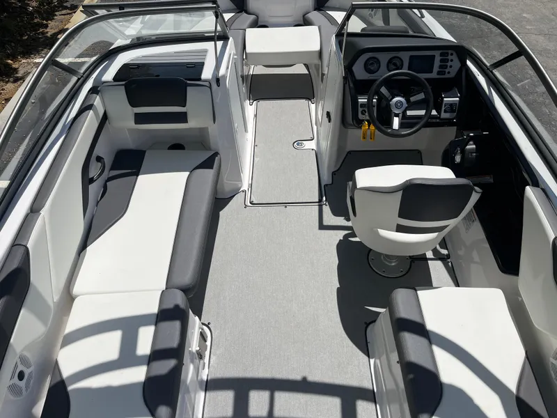 Slide: The Image of 2022 Yamaha AR210 boat interior with seating and steering console. - 13