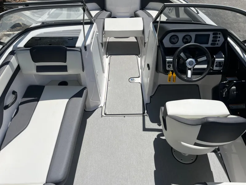 Slide: The Image of 2022 Yamaha Boats AR210 interior with modern dashboard and seating. - 14