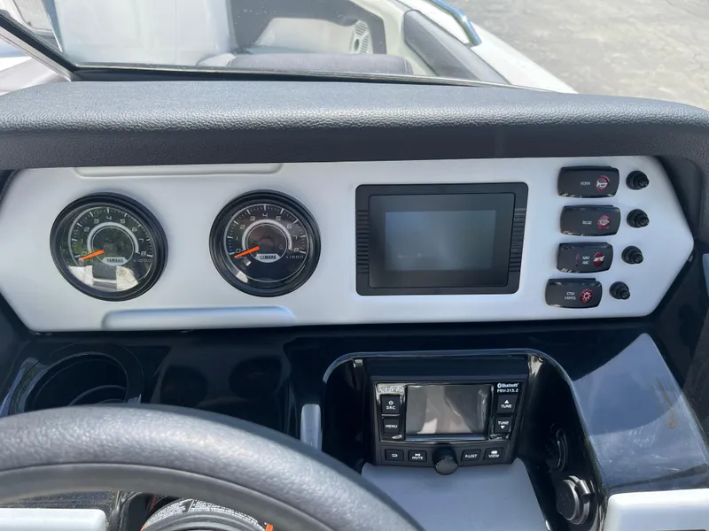 Slide: The Image of Dashboard of 2022 Yamaha Boats AR210 with gauges and control panel. - 17