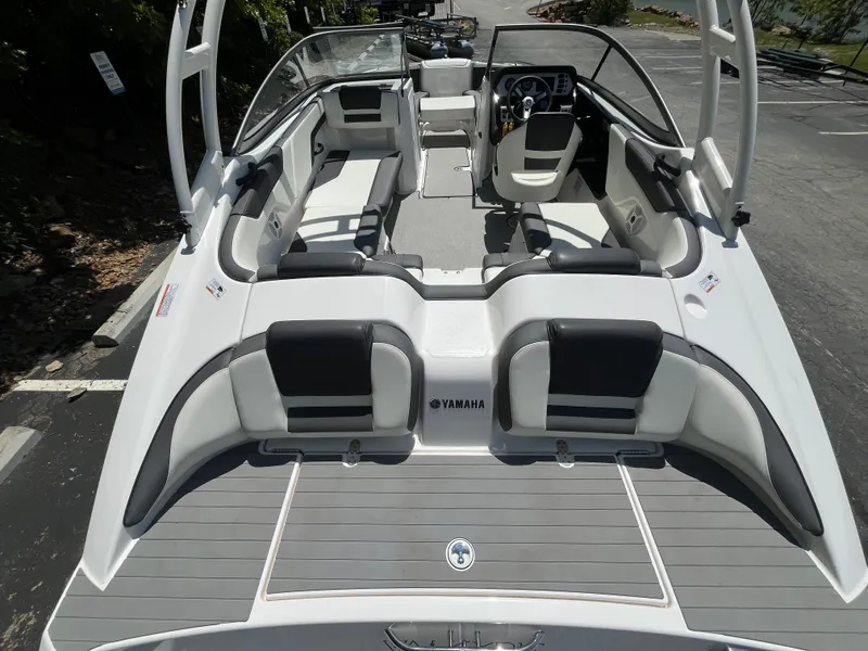 Slide: The Image of 2022 Yamaha Boats AR210 interior, featuring sleek seating and modern dashboard design. - 2