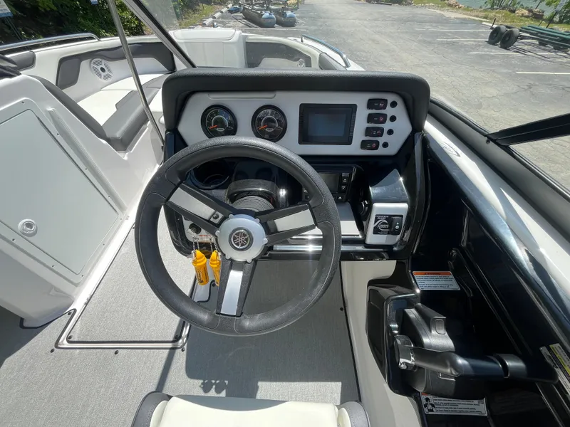 Slide: The Image of 2022 Yamaha Boats AR210 dashboard with steering wheel, gauges, and control panel. - 20