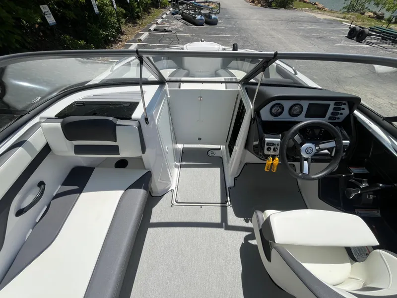 Slide: The Image of 2022 Yamaha Boats AR210 interior with steering wheel, seating, and dashboard controls. - 28