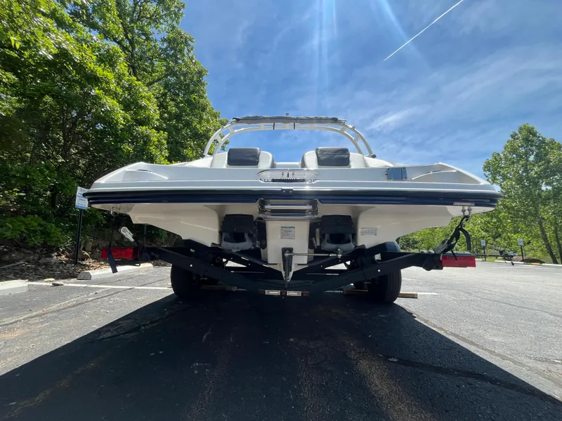 Slide: The Image of 2022 Yamaha AR210 boat on trailer, parked outdoors under clear blue sky. - 6