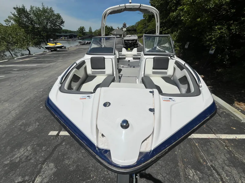 Slide: The Image of 2022 Yamaha AR210 boat with sleek design, docked near a scenic waterfront. - 8