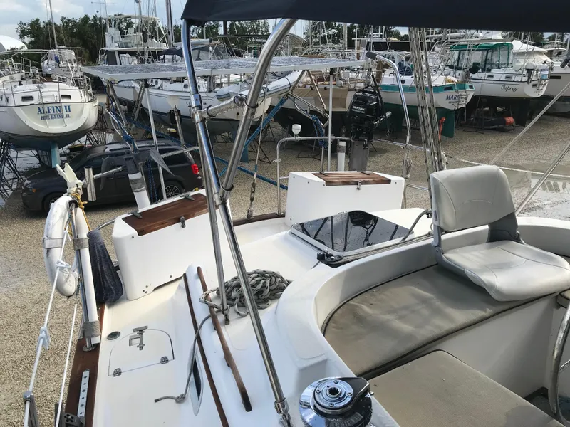Slide: The Image of 1990 Endeavour 38 CC sailboat on stands in a marina under a blue sky. - 11