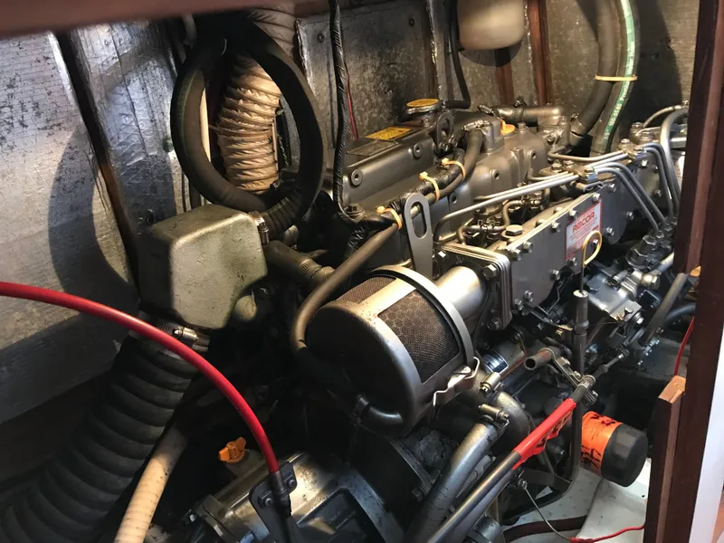 Slide: The Image of Engine compartment of a 1990 Endeavour 38 CC sailboat, showcasing mechanical components and wiring. - 3