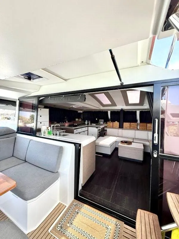 Slide: The Image of Interior of 2022 Fountaine Pajot Elba 45 catamaran, featuring modern seating and spacious design. - 10