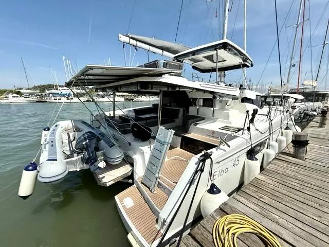 Slide: The Image of 2022 Fountaine Pajot Elba 45 catamaran docked at marina, featuring modern design and amenities. - 4