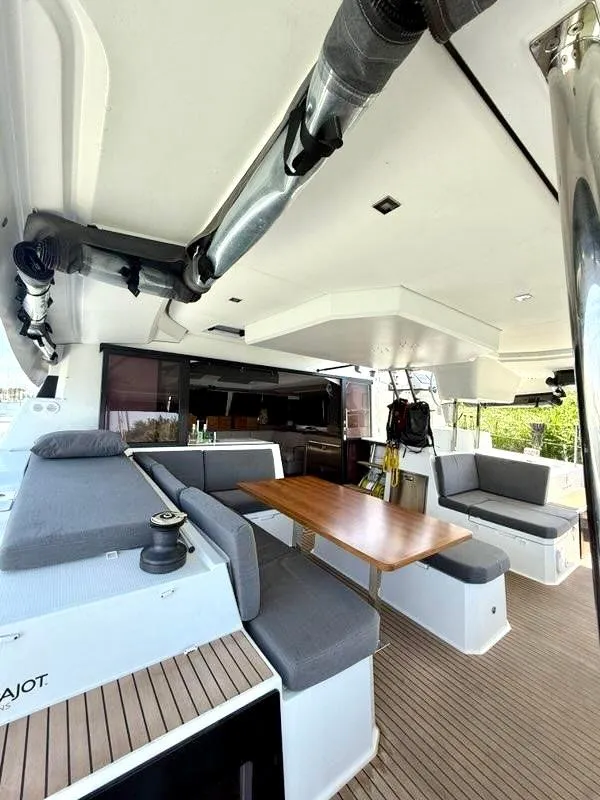 Slide: The Image of 2022 Fountaine Pajot Elba 45 yacht with spacious outdoor seating and dining area. - 9