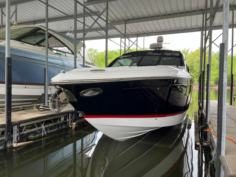 Slide: The Image of 2022 Cobalt A36BR boat docked in a covered marina. - 17