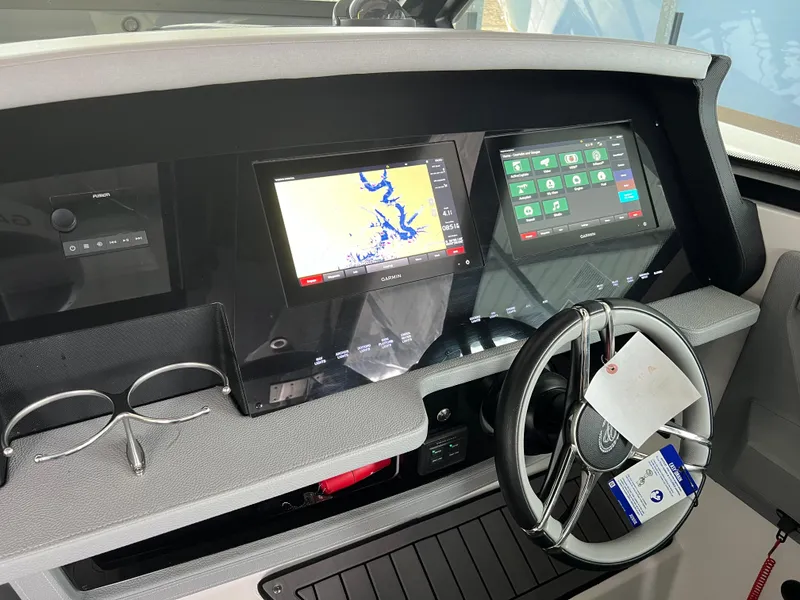 Slide: The Image of Dashboard of 2022 Cobalt A36BR boat with navigation screens and steering wheel. - 21