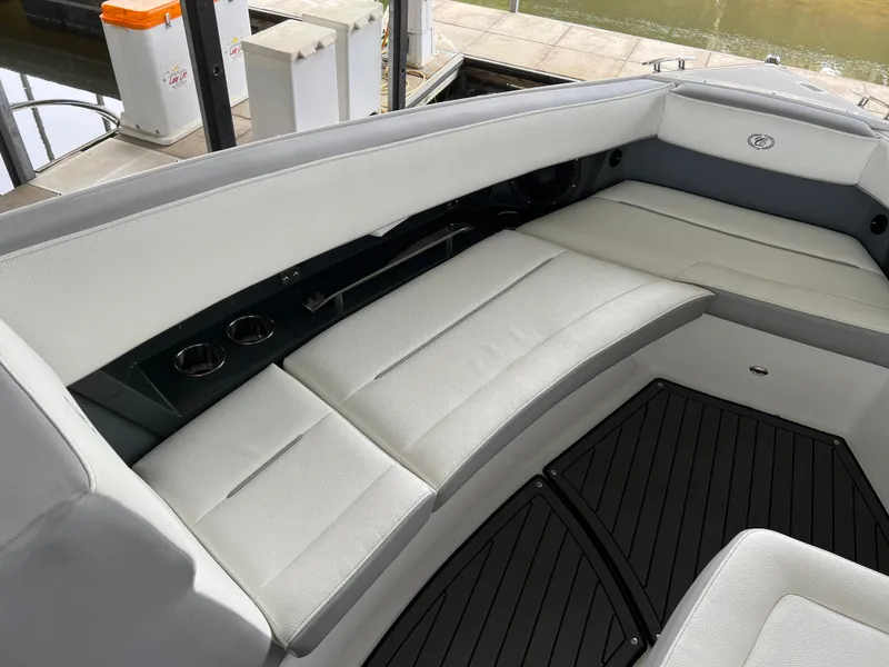 Slide: The Image of 2022 Cobalt A36BR boat interior with white cushioned seating and black flooring. - 22