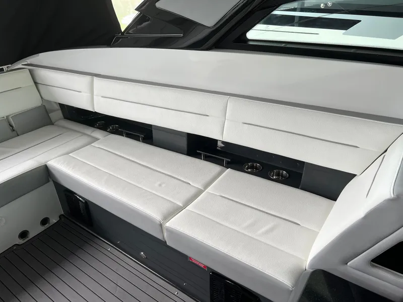 Slide: The Image of 2022 Cobalt A36BR boat interior with sleek white seating and modern design. - 26