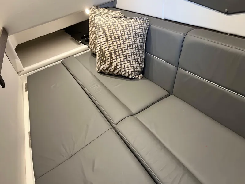 Slide: The Image of 2022 Cobalt A36BR interior with gray leather seating and patterned cushion. - 32