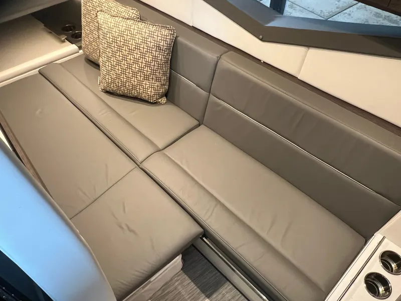 Slide: The Image of 2022 Cobalt A36BR boat interior with gray leather seating and patterned cushions. - 33
