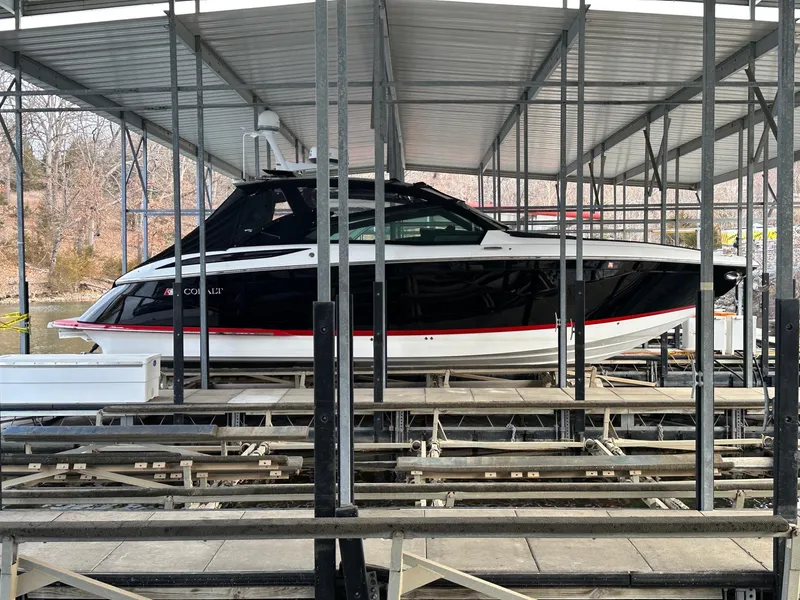 Slide: The Image of 2022 Cobalt A36BR boat docked in a covered marina. - 35