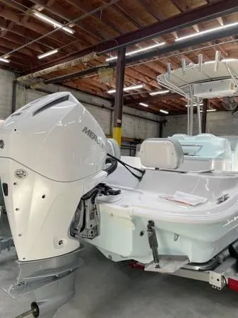 Slide: The Image of 2024 ALK2 Powerboats 25 CRX with Mercury engine in a warehouse setting. - 10