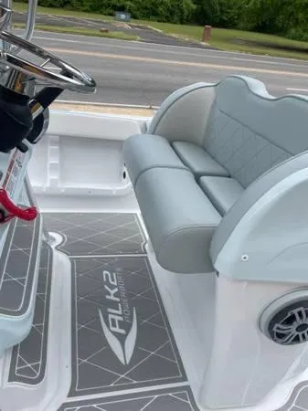 Slide: The Image of 2024 ALK2 Powerboats 25 CRX interior with gray seating and steering wheel. - 13