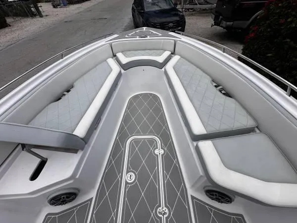 Slide: The Image of 2024 ALK2 Powerboats 25 CRX interior with cushioned seating and sleek design. - 6