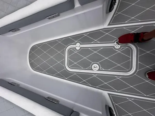 Slide: The Image of 2024 ALK2 Powerboats 25 CRX interior with gray diamond-patterned flooring and red shoes visible. - 7