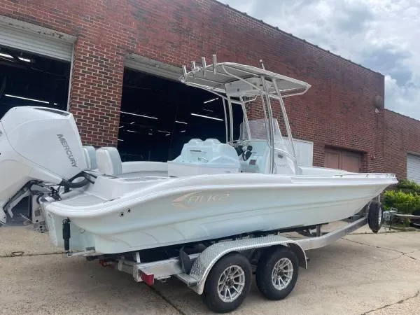 Slide: The Image of 2024 ALK2 Powerboats 25 CRX on trailer, parked outside brick building. - 9