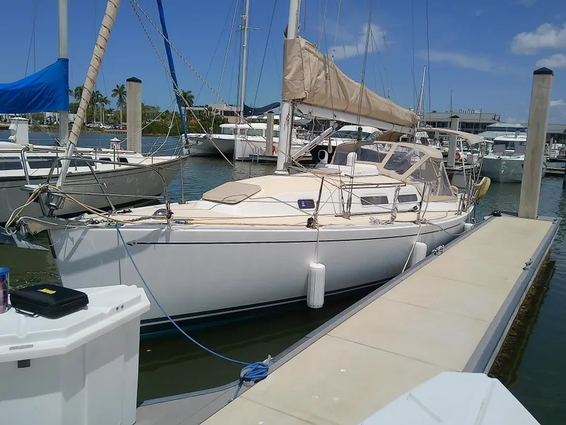 Slide: The Image of 2004 J Boats J/32 sailboat docked at marina under clear blue sky. - 1