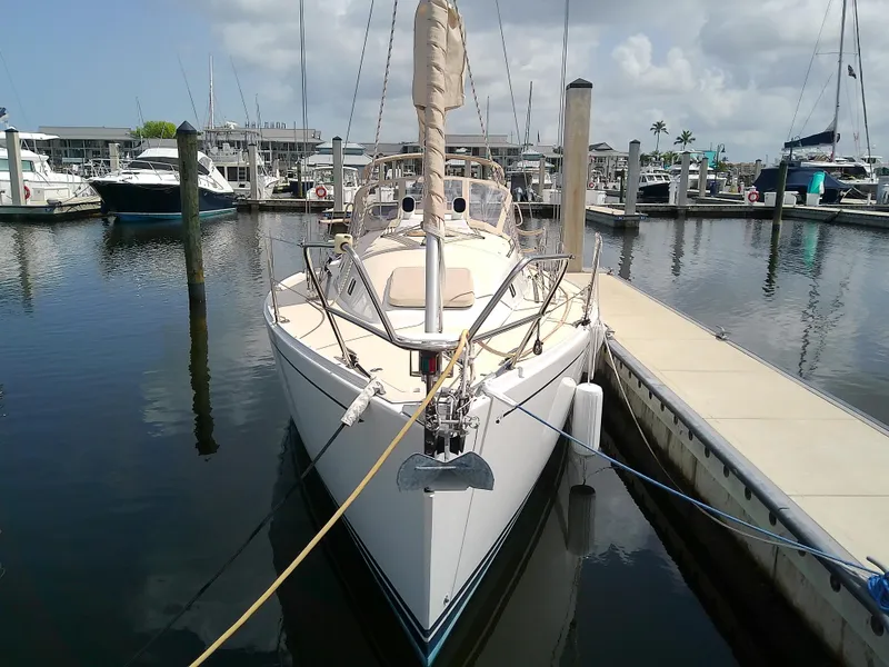 Slide: The Image of 2004 J Boats J/32 sailboat with beige sail cover docked at marina. - 12