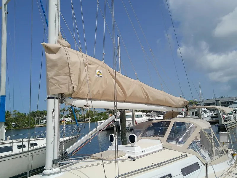 Slide: The Image of 2004 J Boats J/32 sailboat docked in a marina under a clear blue sky. - 13