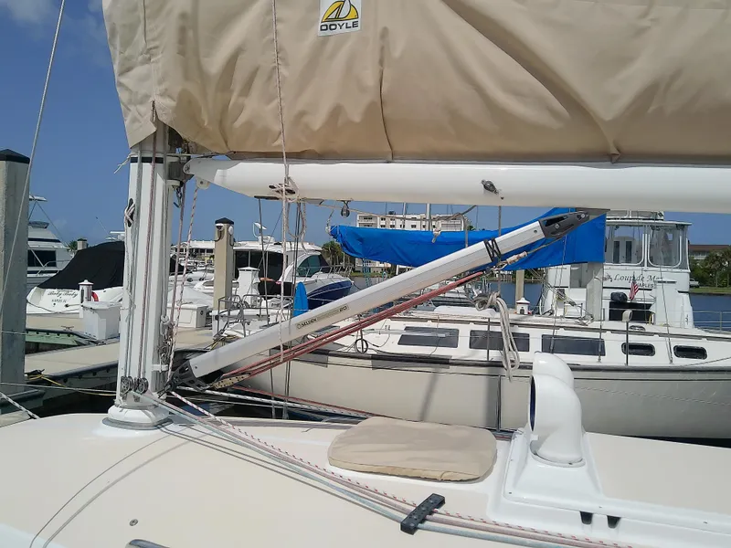 Slide: The Image of 2004 J Boats J/32 sailboat deck view at marina, showcasing rigging and mast. - 14