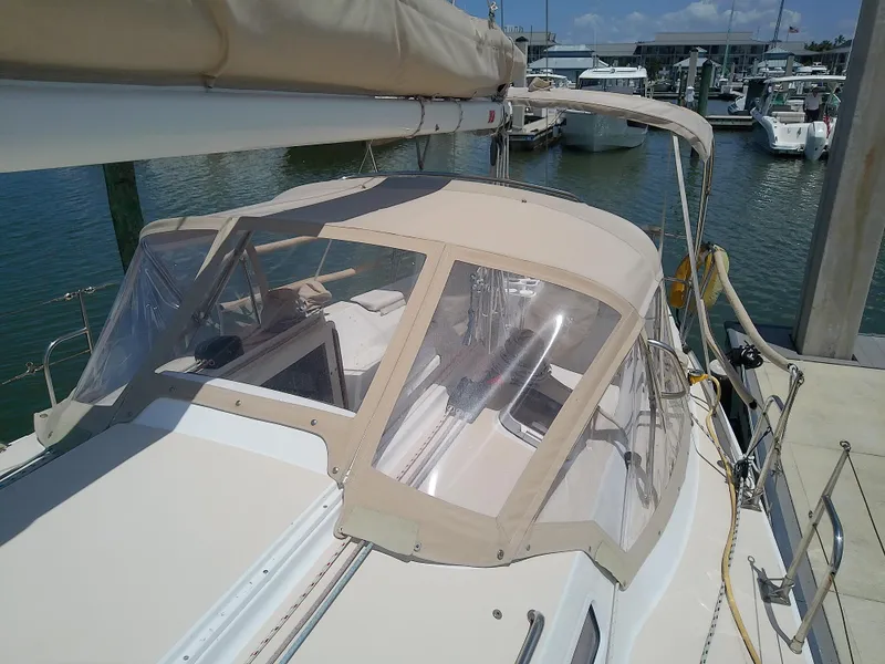 Slide: The Image of 2004 J Boats J/32 sailboat docked at marina with beige canopy. - 21