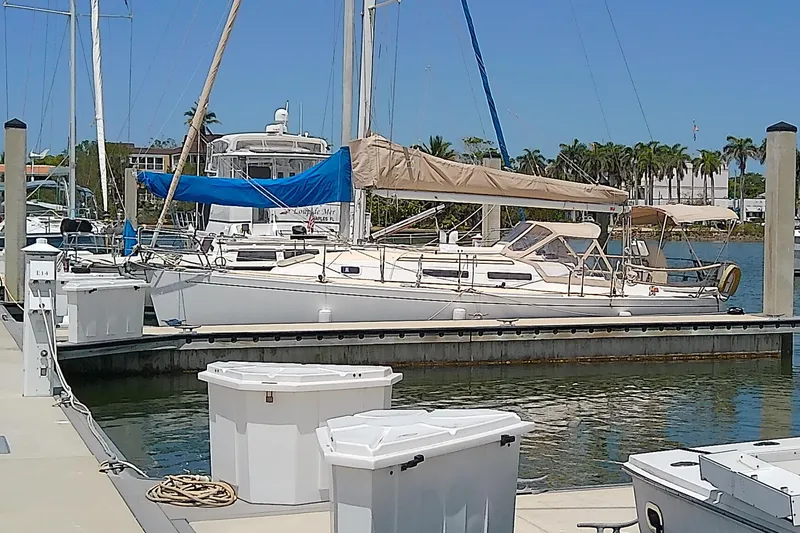 Slide: The Image of 2004 J Boats J/32 sailboat docked at marina under clear sky. - 5