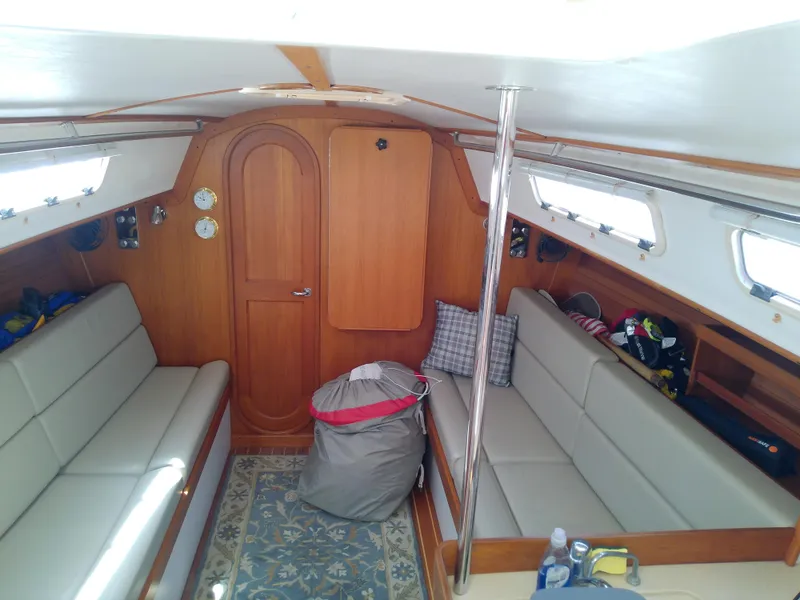Slide: The Image of Interior of a 2004 J Boats J/32 sailboat, featuring a cozy cabin with wooden accents. - 50