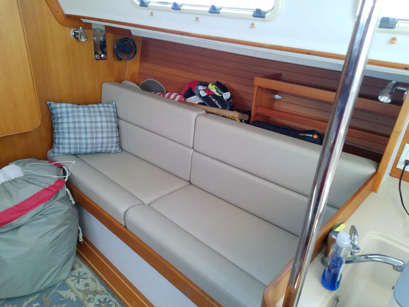 Slide: The Image of Interior of 2004 J Boats J/32 sailboat with beige seating and wooden accents. - 52