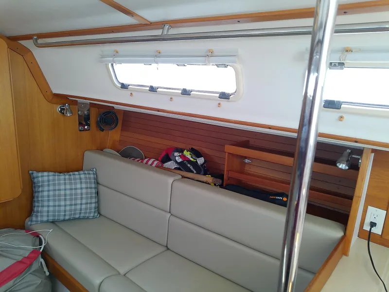 Slide: The Image of Interior of 2004 J Boats J/32 sailboat with beige seating and wooden accents. - 53