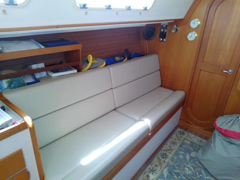 Slide: The Image of Interior of a 2004 J Boats J/32 sailboat with beige seating and wooden accents. - 54