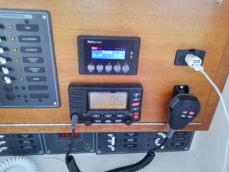 Slide: The Image of Control panel of a 2004 J Boats J/32 sailboat, featuring various switches and displays. - 57