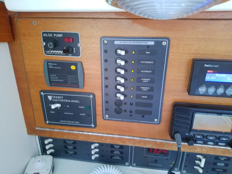 Slide: The Image of Interior of 2004 J Boats J/32 sailboat with wooden paneling and cushioned seating. - 58