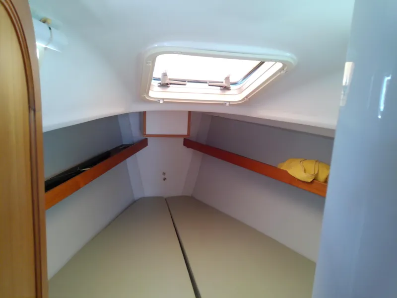 Slide: The Image of Storage compartment on a 2004 J Boats J/32, containing life jackets and equipment. - 62
