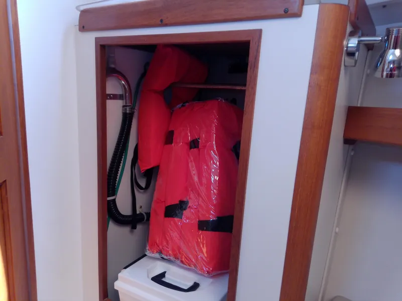 Slide: The Image of 2004 J Boats J/32 interior with wooden cabinetry and mounted fire extinguisher. - 63