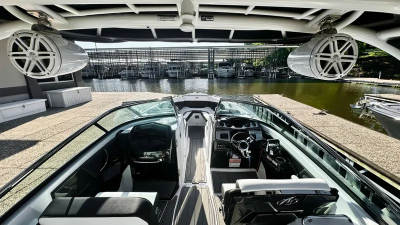 Slide: The Image of 2022 Monterey 298SS boat interior with sleek design and advanced controls, docked by the water. - 4
