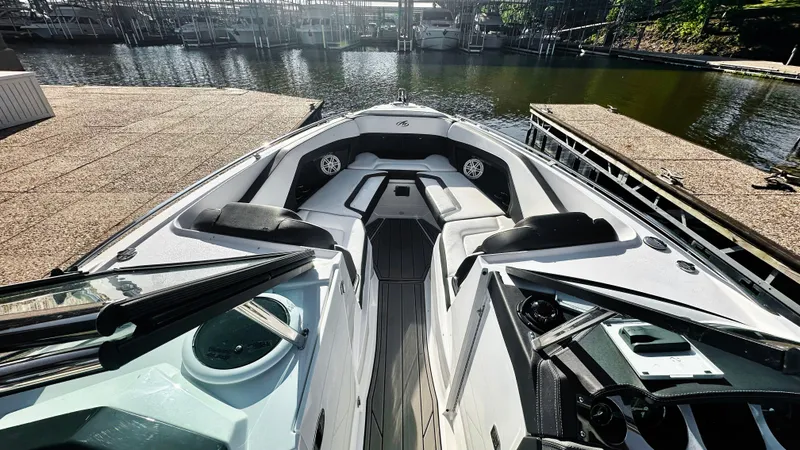 Slide: The Image of 2022 Monterey 298SS boat interior at dock, featuring sleek seating and modern design. - 5