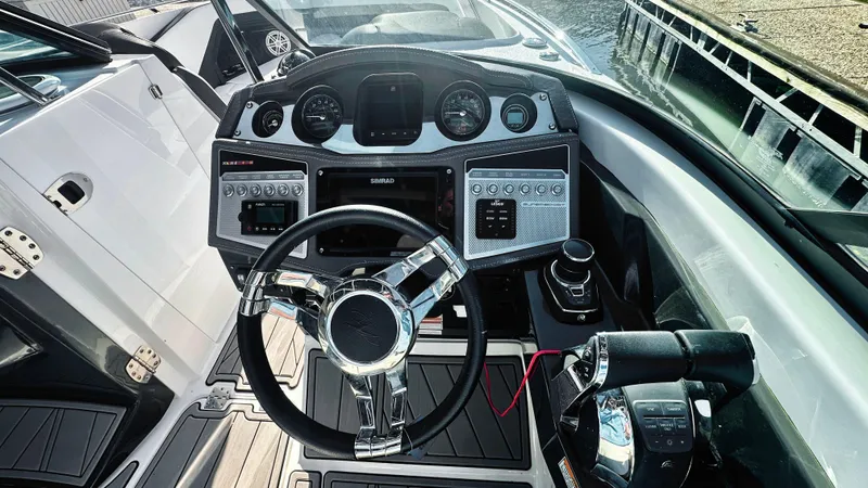 Slide: The Image of 2022 Monterey 298SS boat dashboard with modern controls and steering wheel. - 6