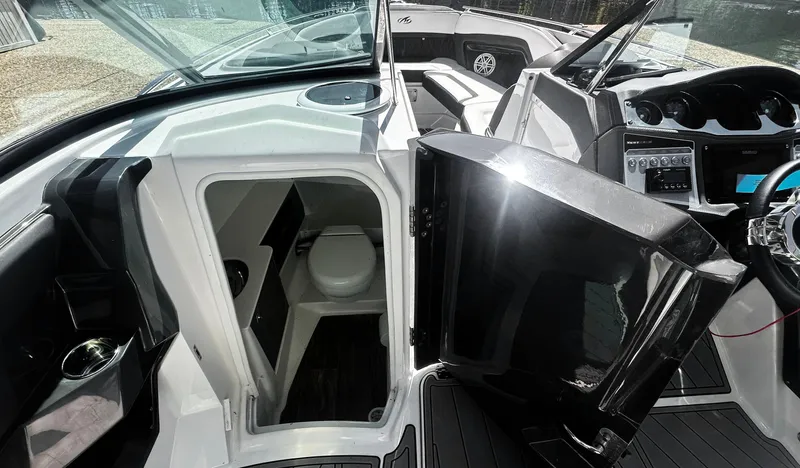 Slide: The Image of 2022 Monterey 298SS boat interior with open cabin door and visible toilet. - 8