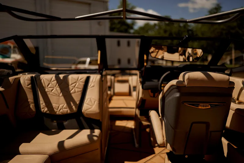 Slide: The Image of Luxurious interior of 2025 Nautique Super Air Nautique G25 Paragon boat with beige seating. - 12