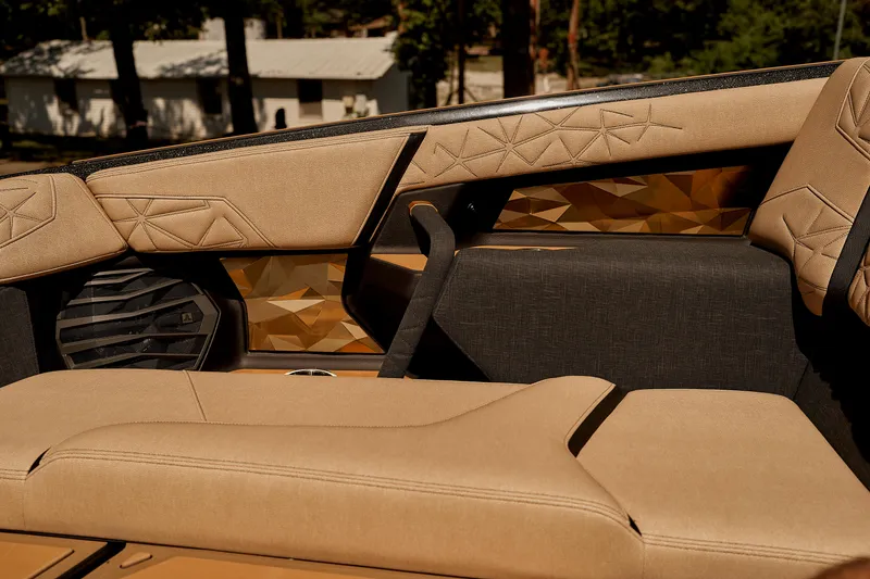 Slide: The Image of 2025 Nautique Super Air Nautique G25 Paragon interior with luxurious tan seating and geometric accents. - 16