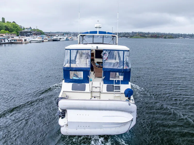 Slide: The Image of 1988 Tollycraft 44 CPMY cruising on a calm lake with overcast skies. - 23